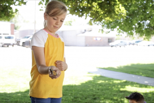 Young girl holding a Monarch Butterfly