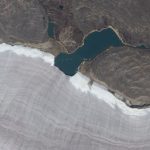 A Mini Lake Splitting Canada’s Ancient Glacier Rim Caught on Satellite